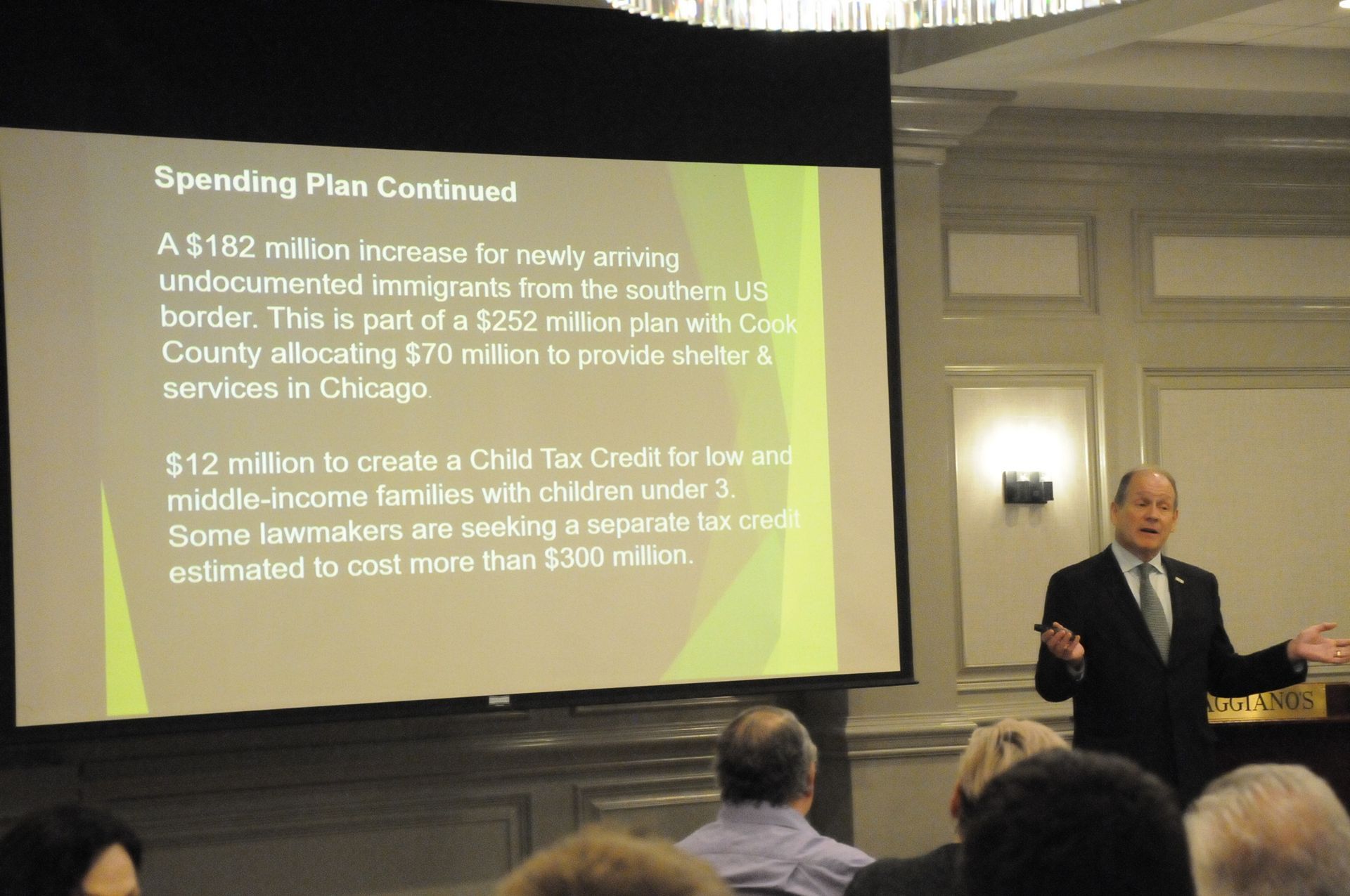 A man is giving a presentation about spending plan continued