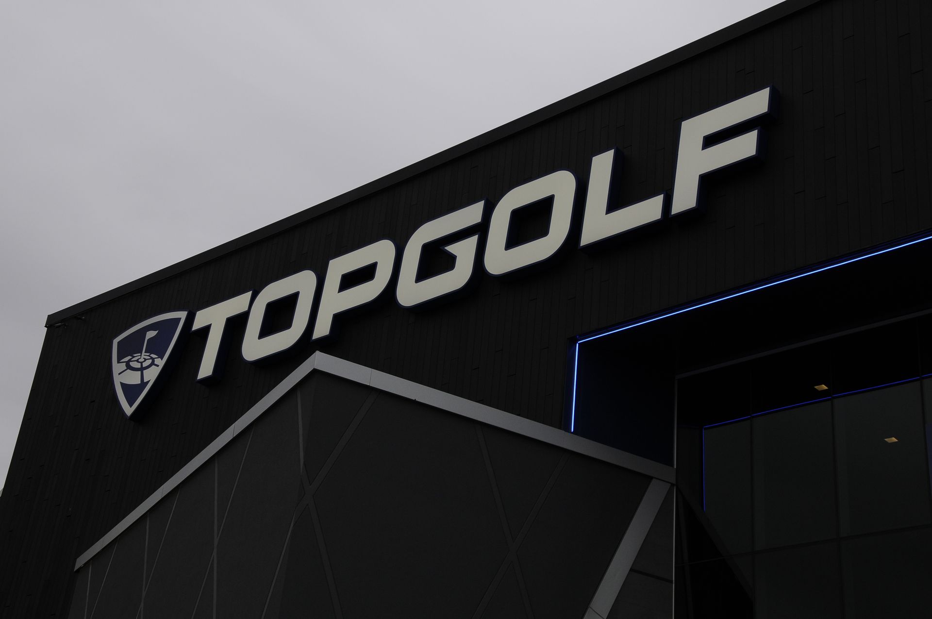 A black building with the word topgolf on it