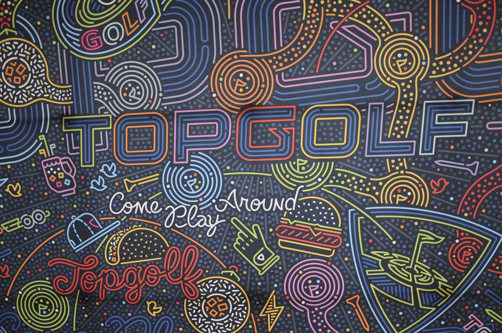 A neon sign that says topgolf come around