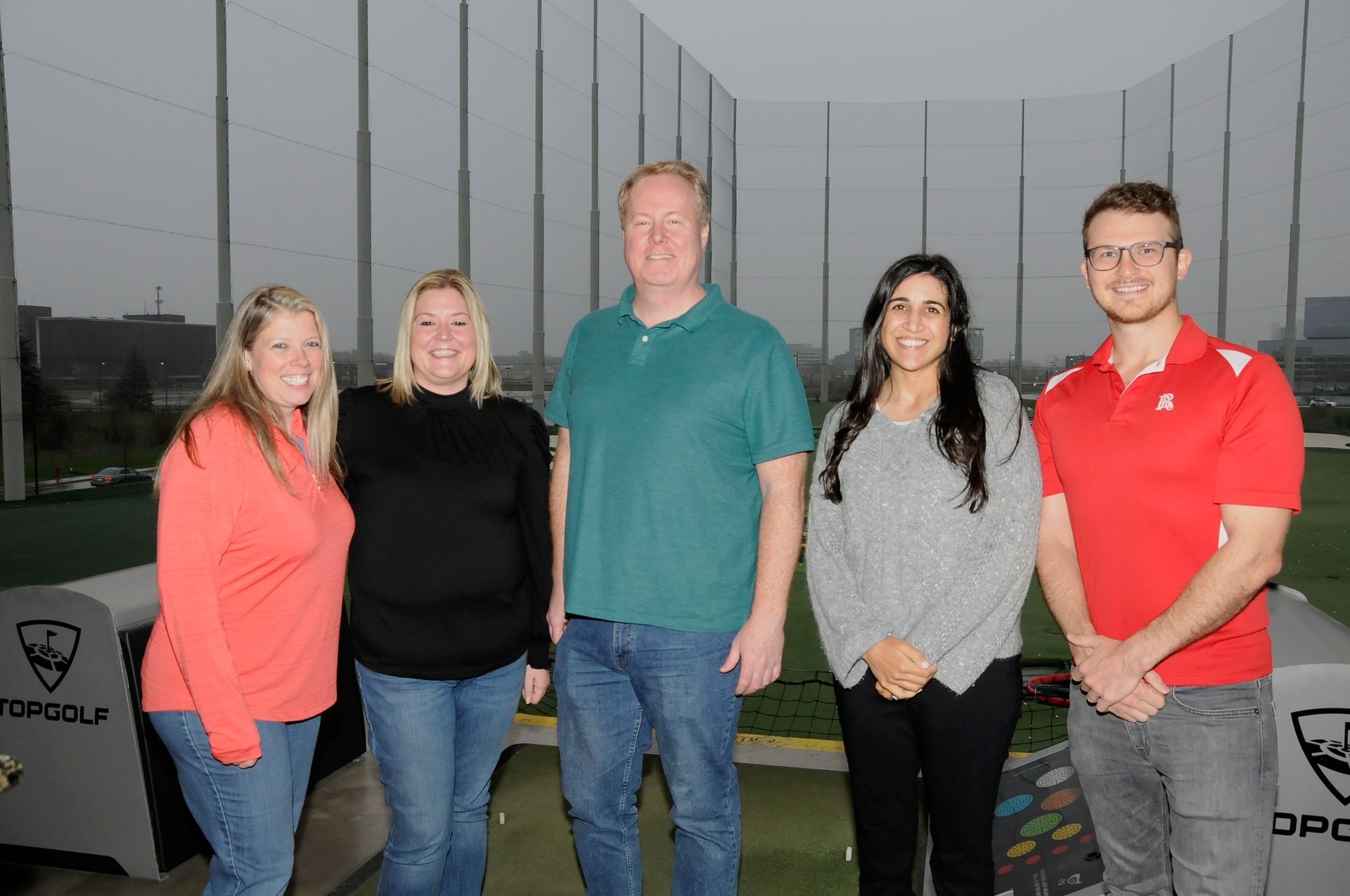 A group of people are posing for a picture on a golf course.