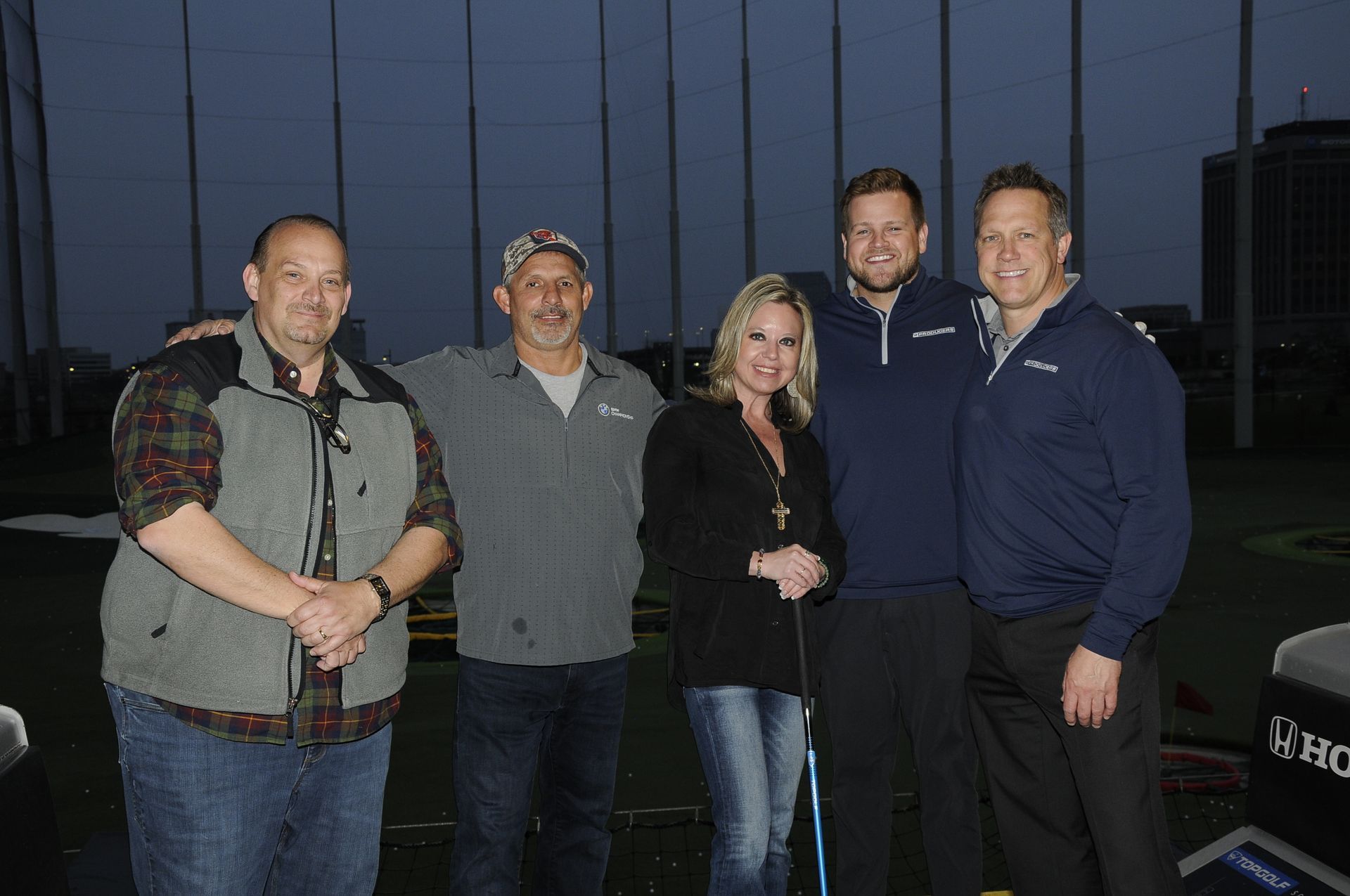 A group of people are posing for a picture on a golf course.