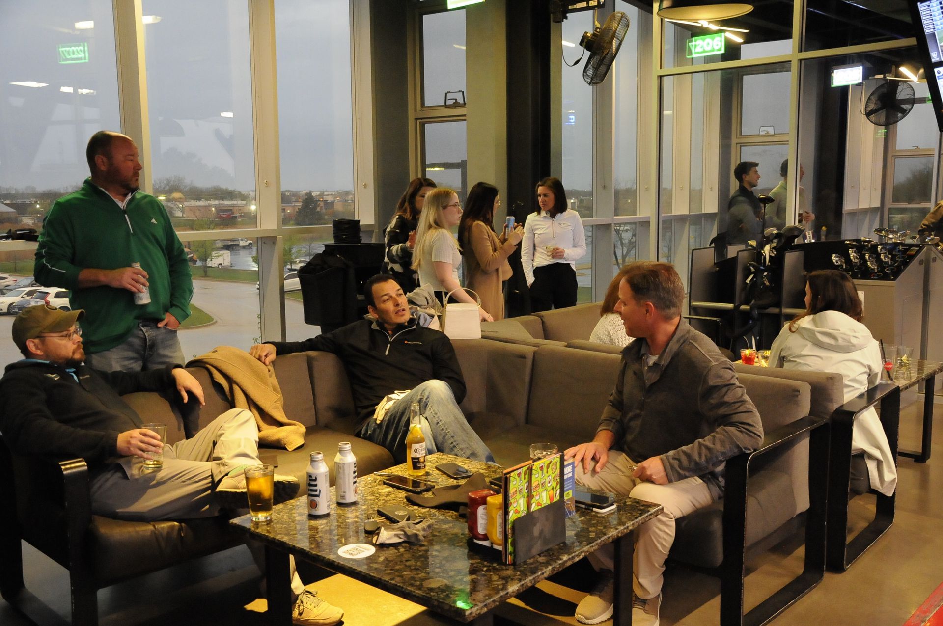 A group of people are sitting on a couch in a restaurant