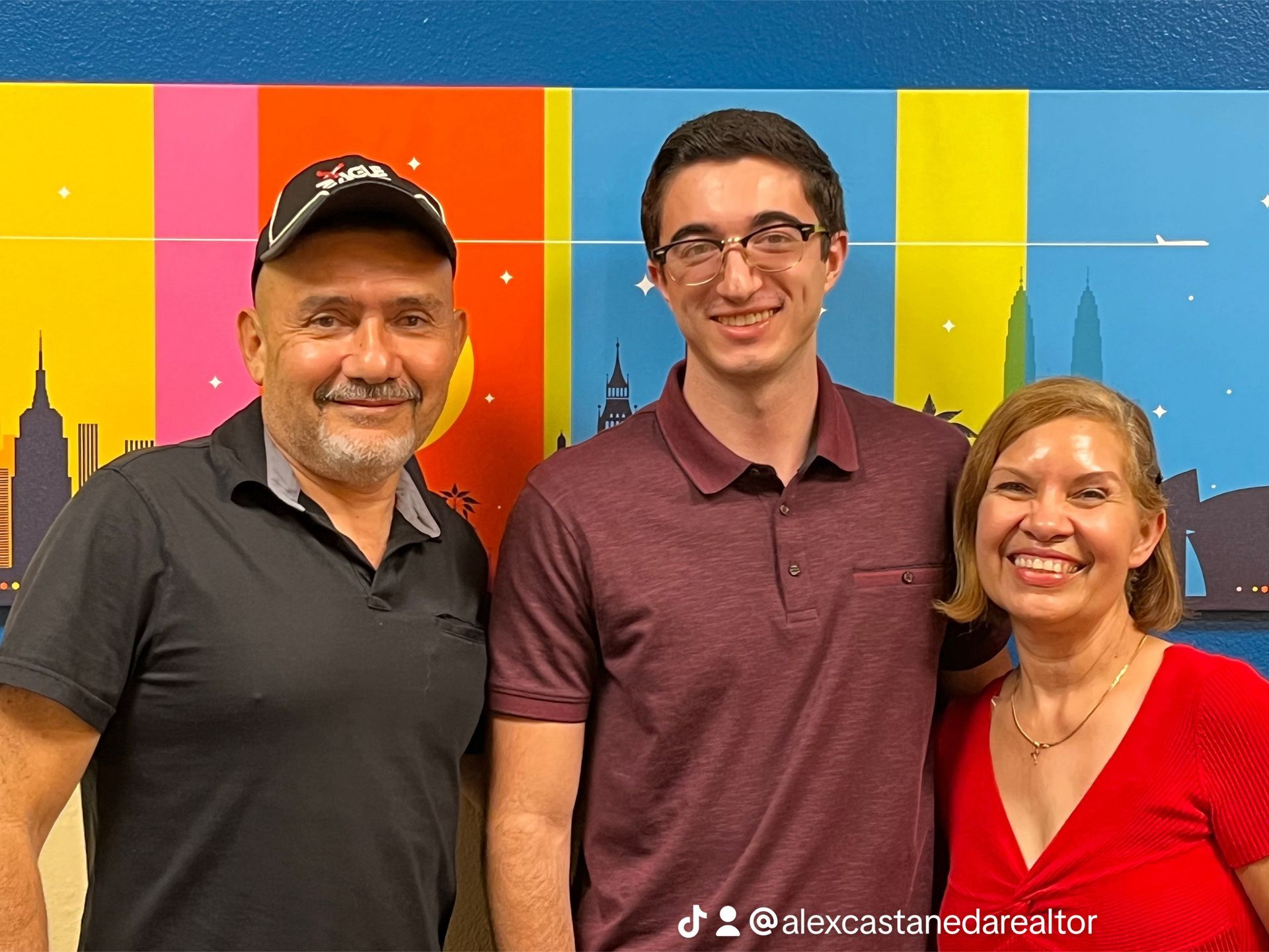 A dining room with a table and chairs and a wooden staircase.