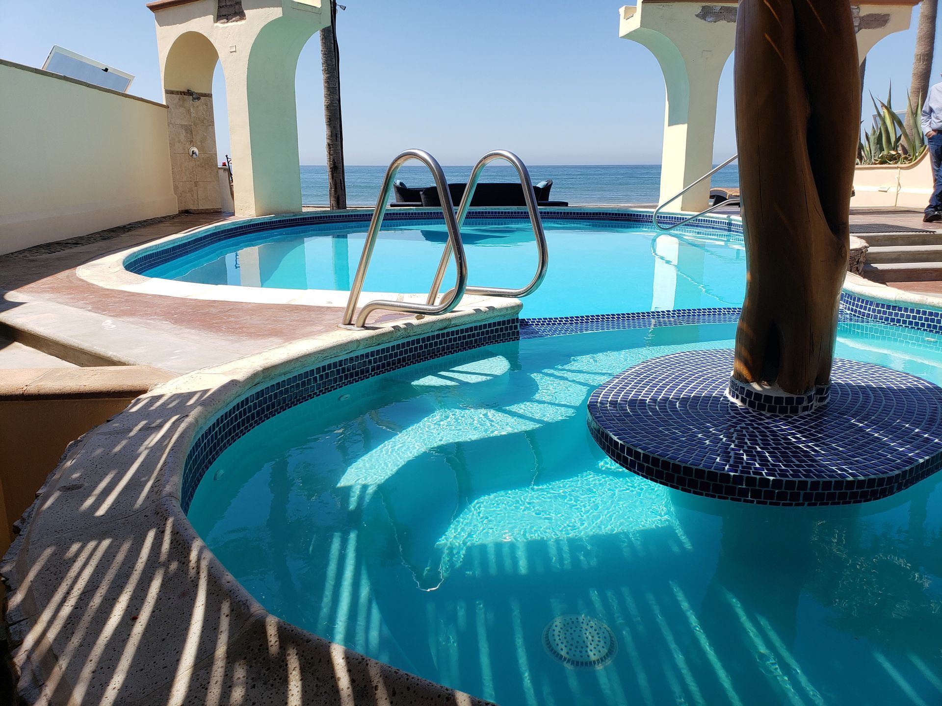 A vase of flowers is sitting on a table next to a window.
