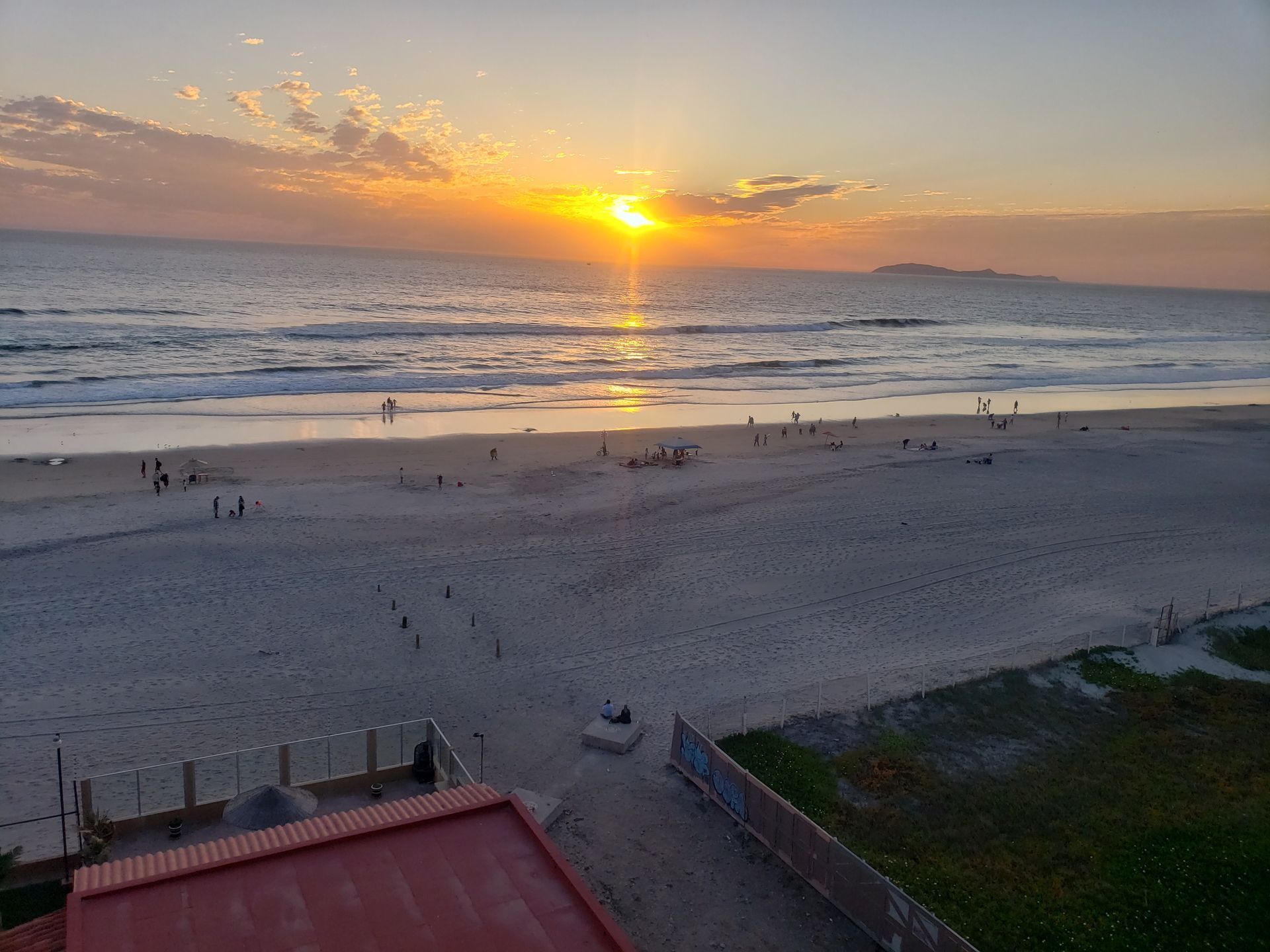 A living room with a couch , chairs , ottoman and a mirror
