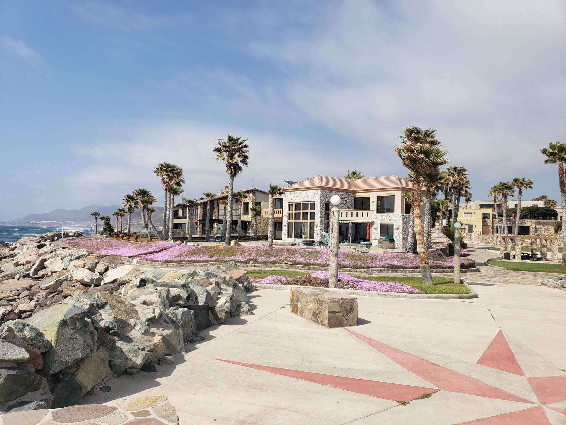 A patio with a lot of furniture and lights at night.