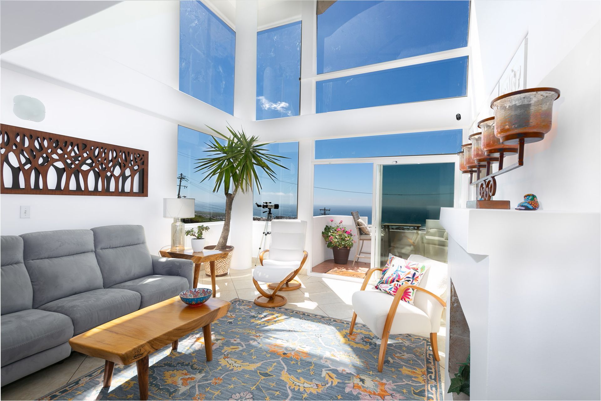 A dining room with a table and chairs and a wooden staircase.
