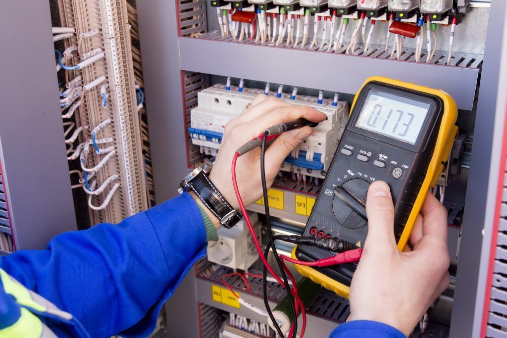 Worker Testing Switches Using Meter — Raleigh, NC — The Madison Energy Group
