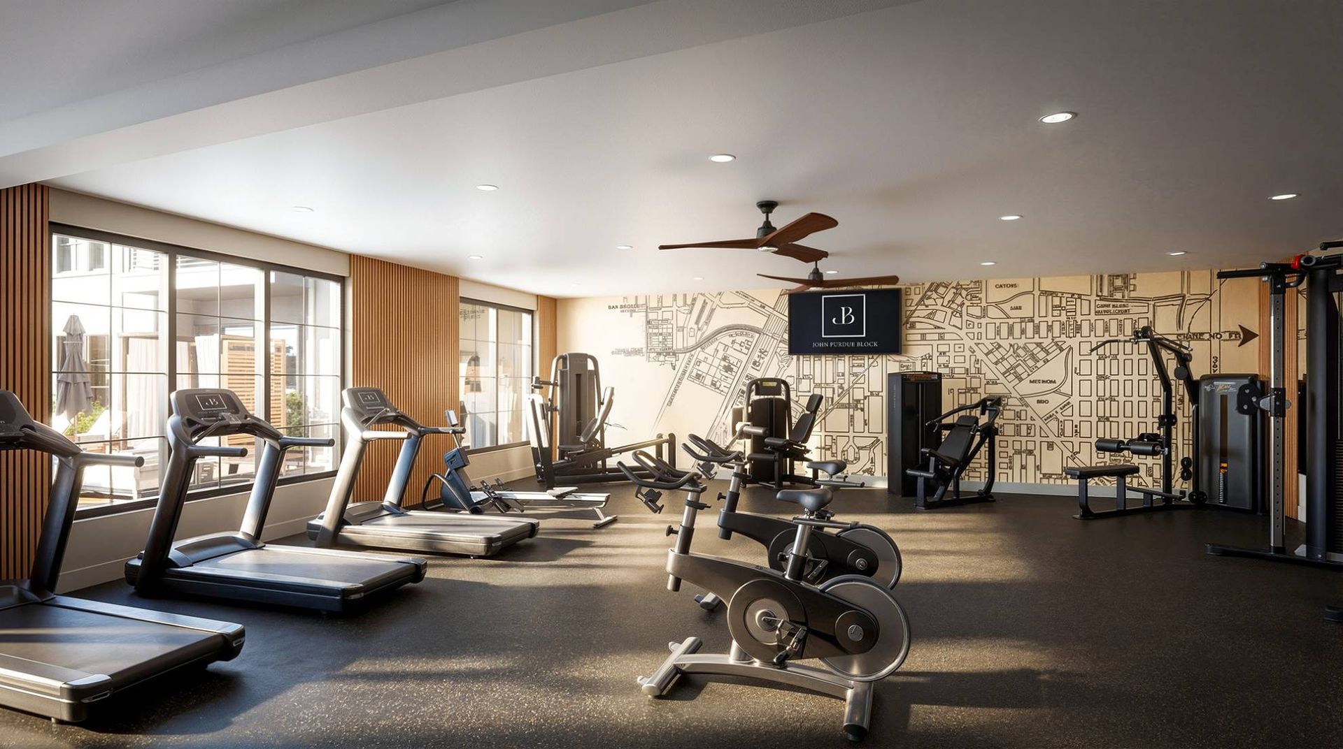Indoor fitness center at a multifamily property with treadmills, bikes, and weight machines.