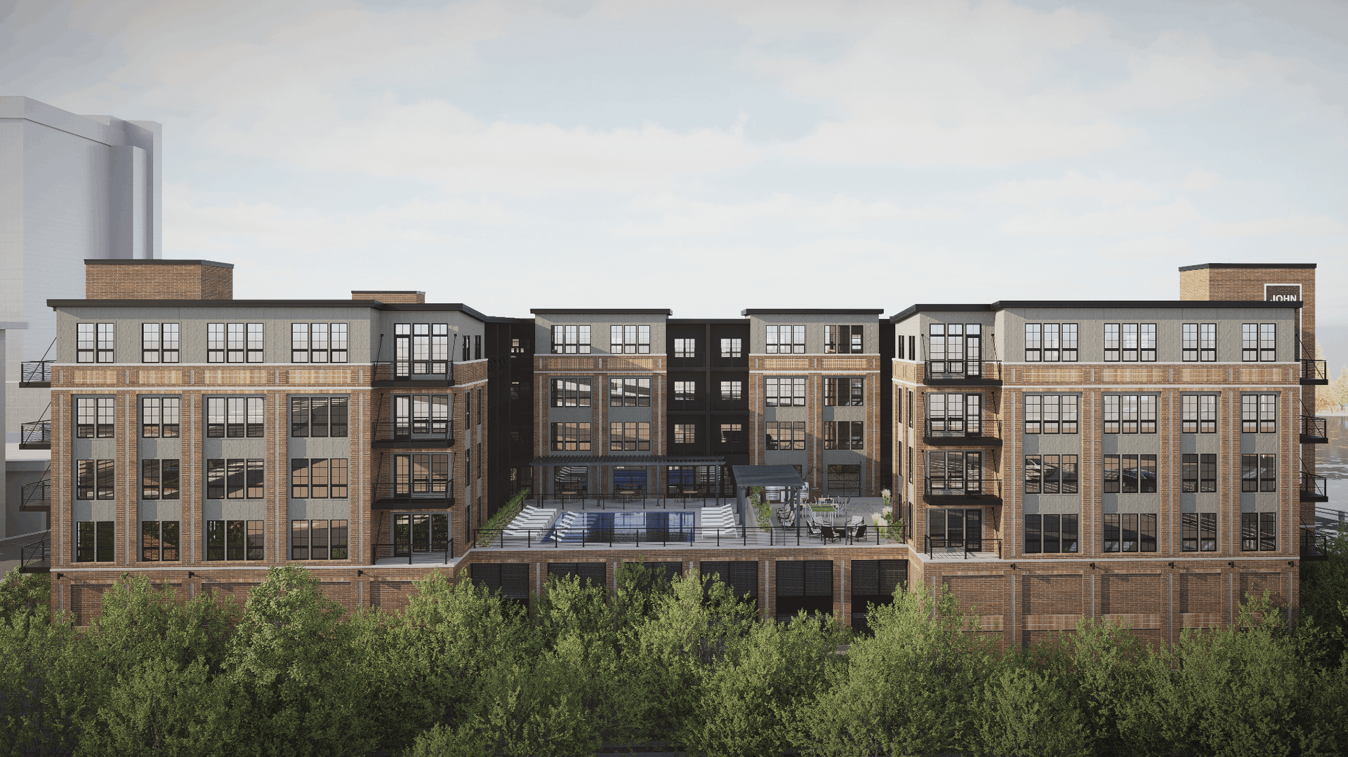 Exterior view of a multi-story brick apartment building with balconies and a central courtyard/pool.