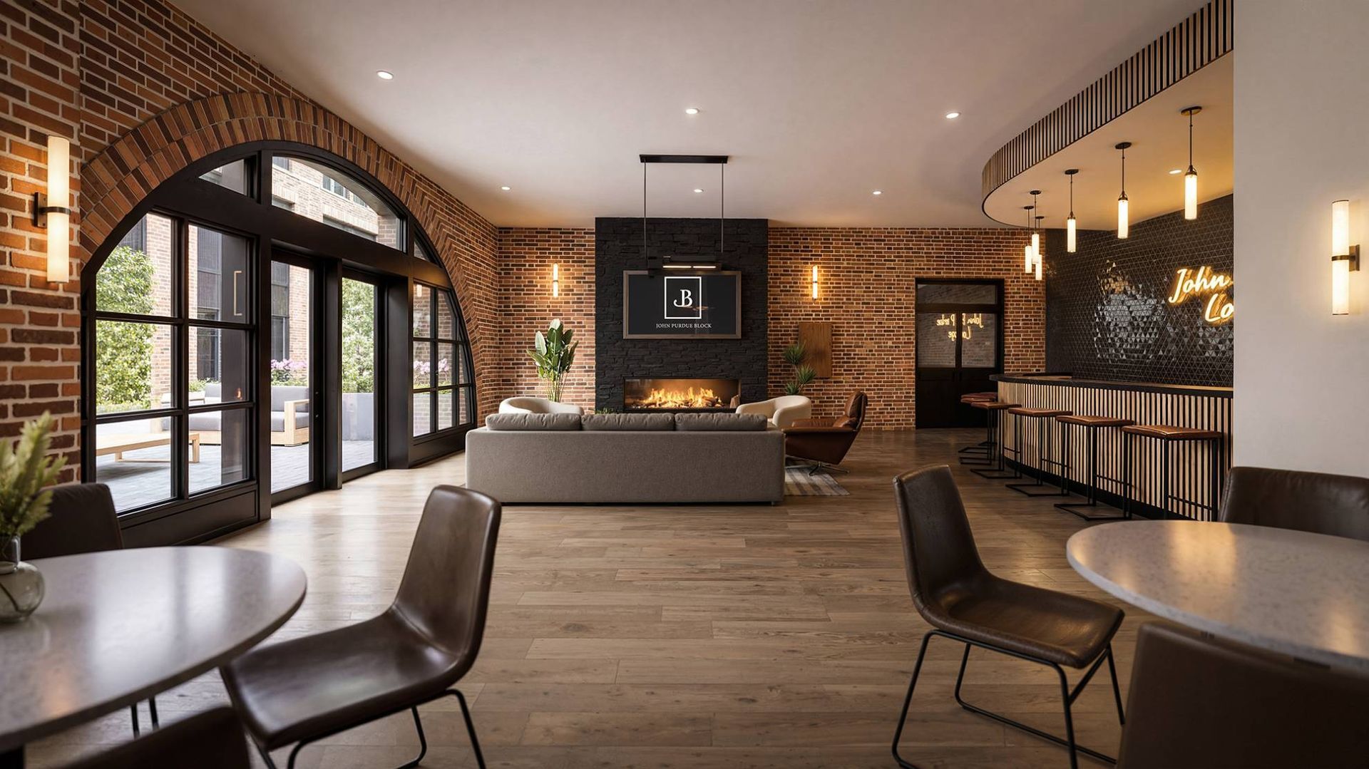 Lobby with brick walls, arched windows, fireplace, and seating.