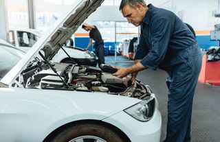 Vehicle Maintenance — Mechanic with Diagnostic Device in Kokomo, IN