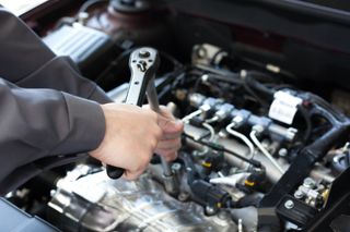 Auto Engine Repair — Hand with Wrench in Kokomo, IN
