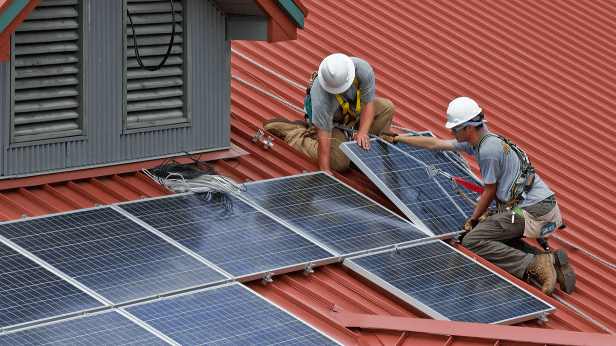 workers installing commercial solar panels