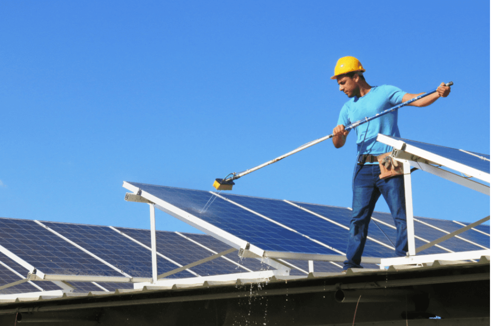 man leaning solar commercial solar panels
