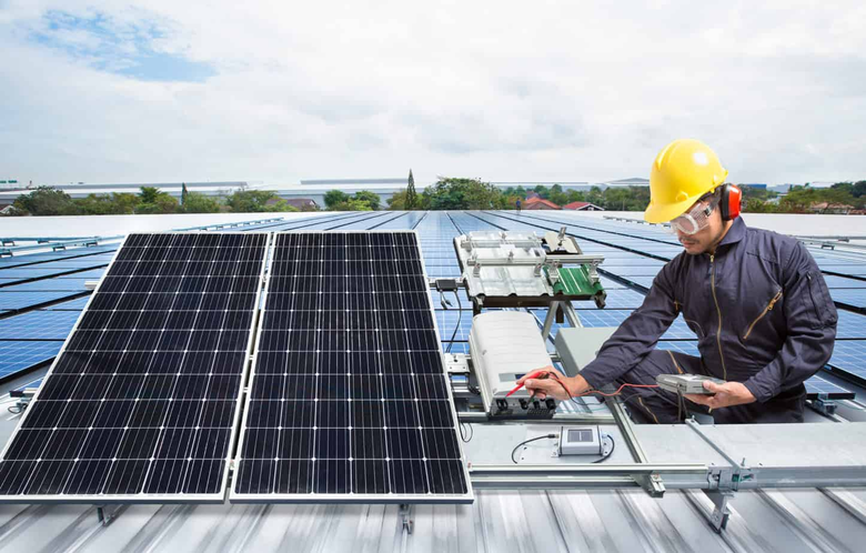 solar panel technician checking solar panels