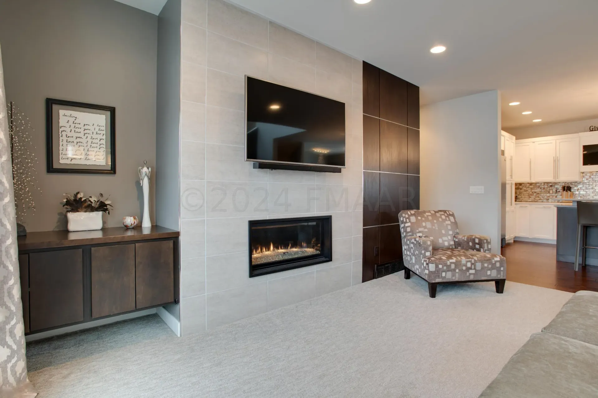 A living room with a couch , chair , table and rug.