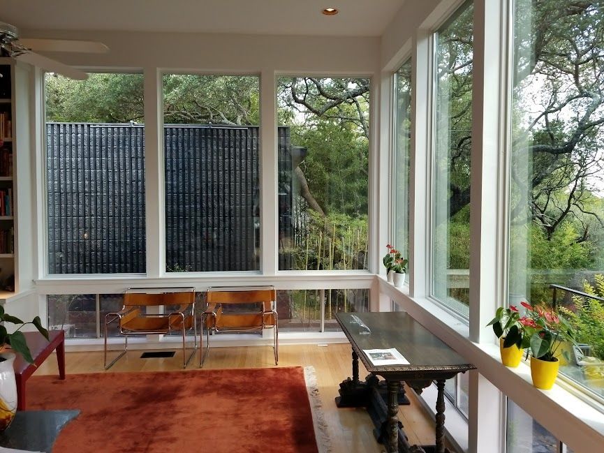 A large deck with sliding glass doors leading to a balcony.