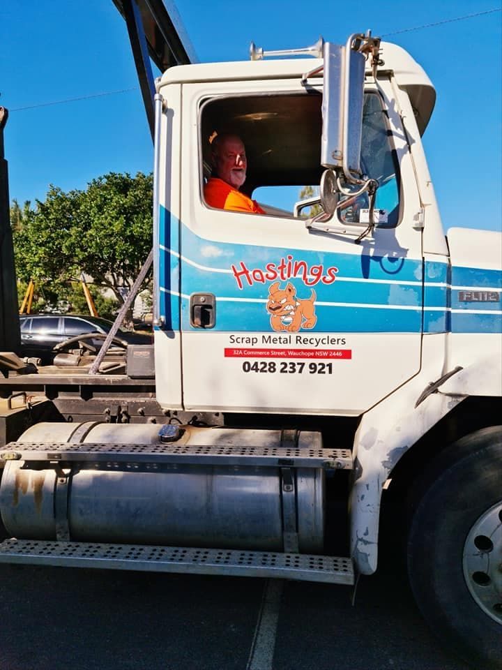 A Man is Driving a Truck That Says Hostings — Hastings Scrap Metal Recyclers in Wauchope, NSW
