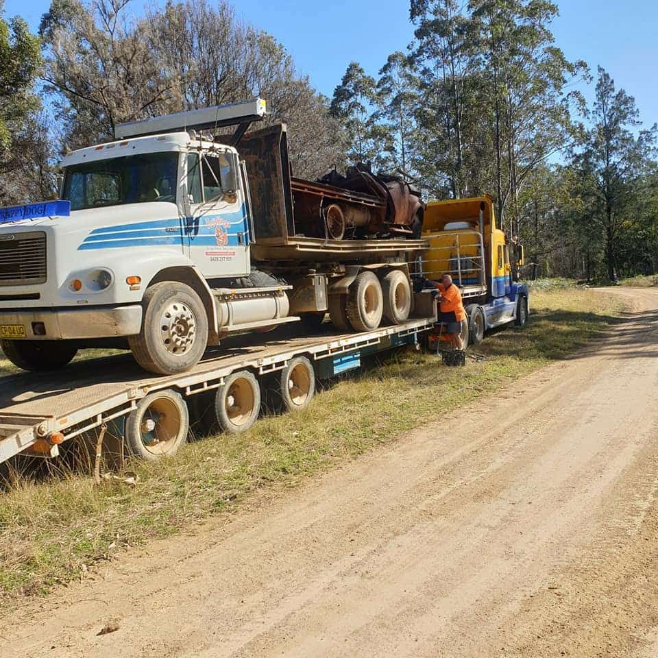 A Truck With a Flatbed is Parked on the Side of a Dirt Road — Hastings Scrap Metal Recyclers in Port Macquarie, NSW