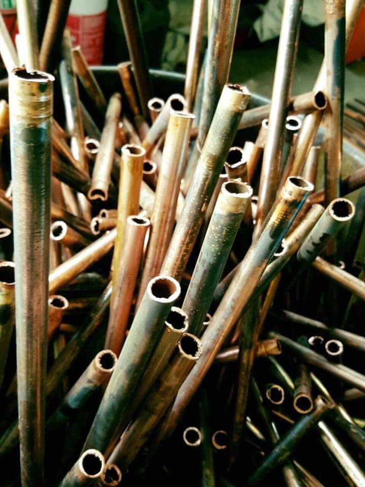 A Pile of Bamboo Sticks With Holes in Them — Hastings Scrap Metal Recyclers in Wauchope, NSW