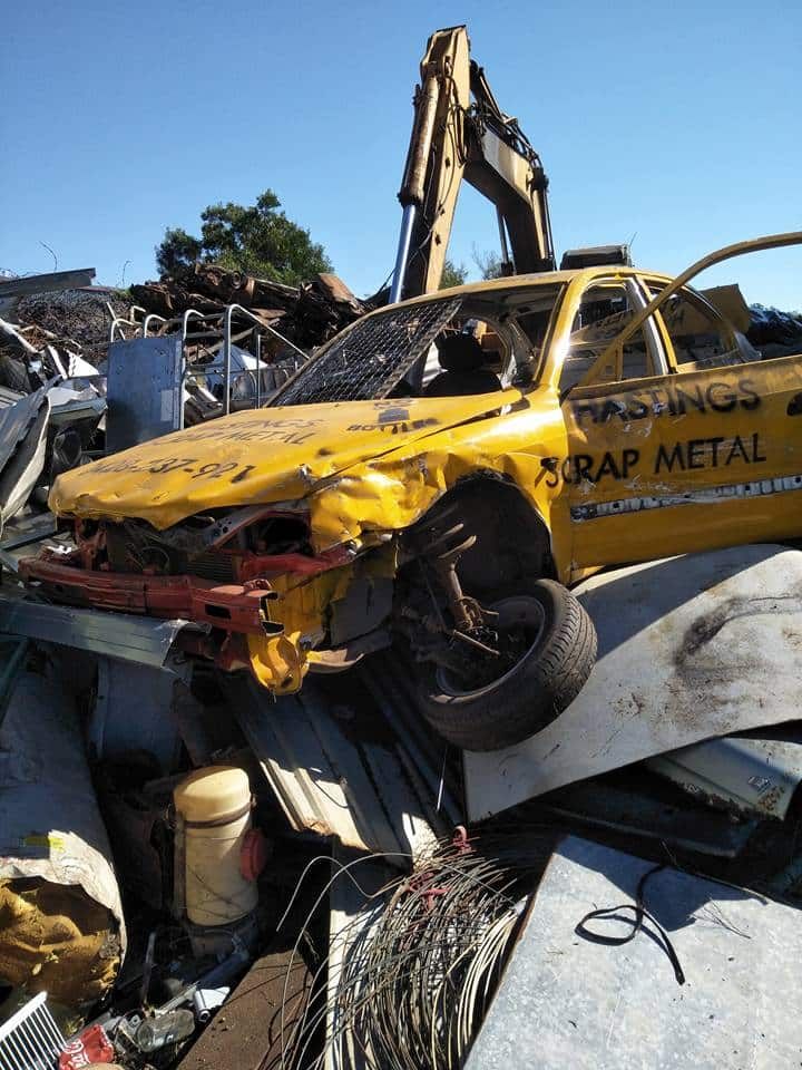 A Yellow Car is Sitting on Top of a Pile of Scrap Metal — Hastings Scrap Metal Recyclers in Wauchope, NSW