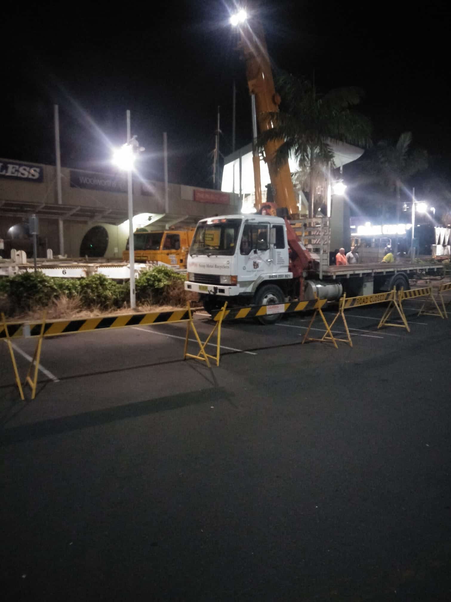 A Man in a Yellow Shirt is Standing in Front of a White Truck — Hastings Scrap Metal Recyclers in Kempsey, NSW