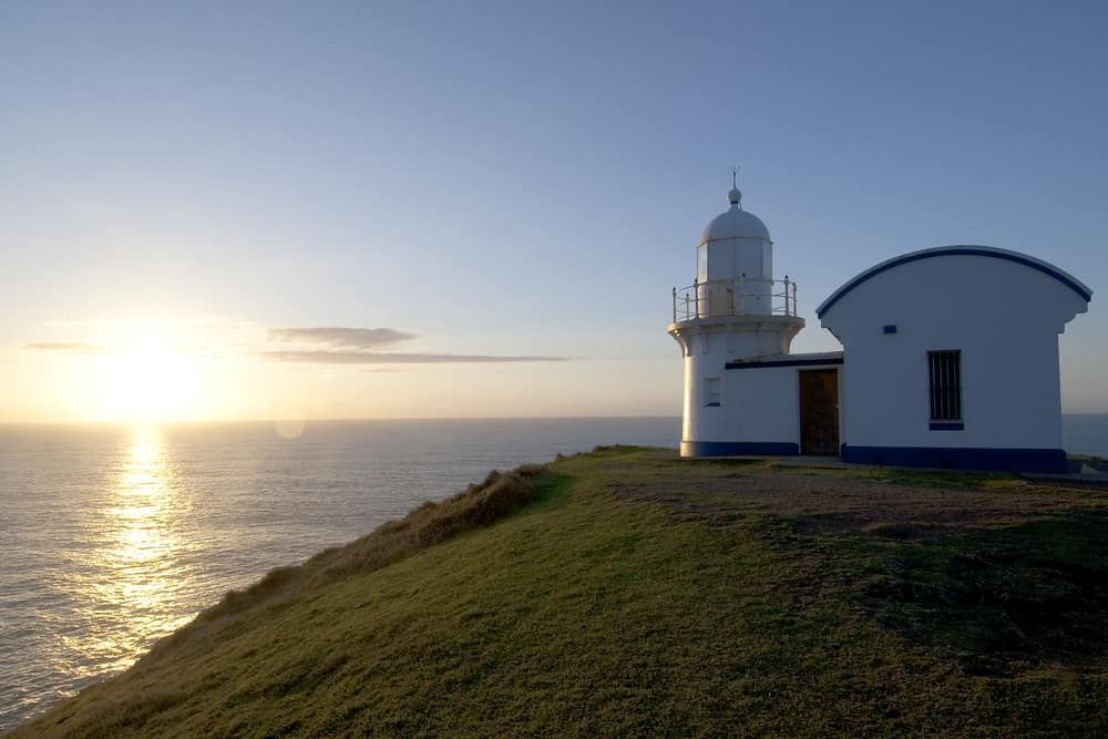 A Lighthouse on a Hill Overlooking the Ocean at Sunset — Hastings Scrap Metal Recyclers in Port Macquarie, NSW