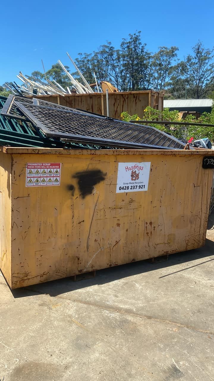 A Man is Sitting in the Driver 's Seat of an Excavator — Hastings Scrap Metal Recyclers in Wauchope, NSW