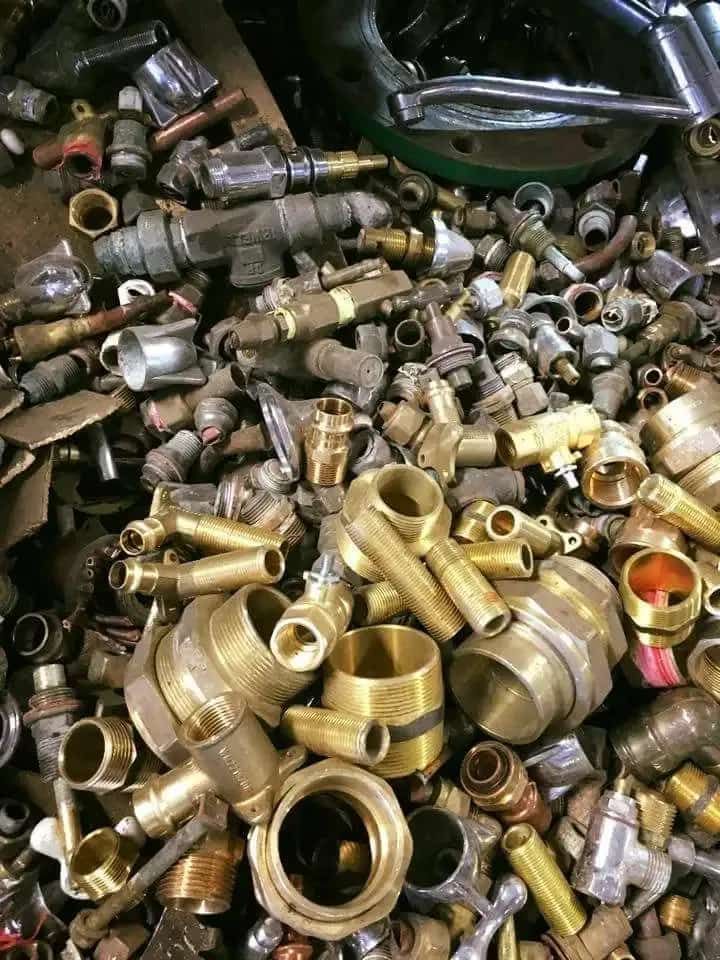 A Pile of Brass Scrap is Sitting on Top of a Table — Hastings Scrap Metal Recyclers in Laurieton, NSW