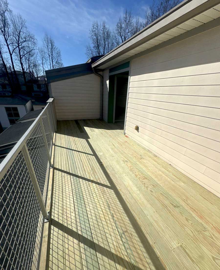 A wooden deck is being built on the side of a house.
