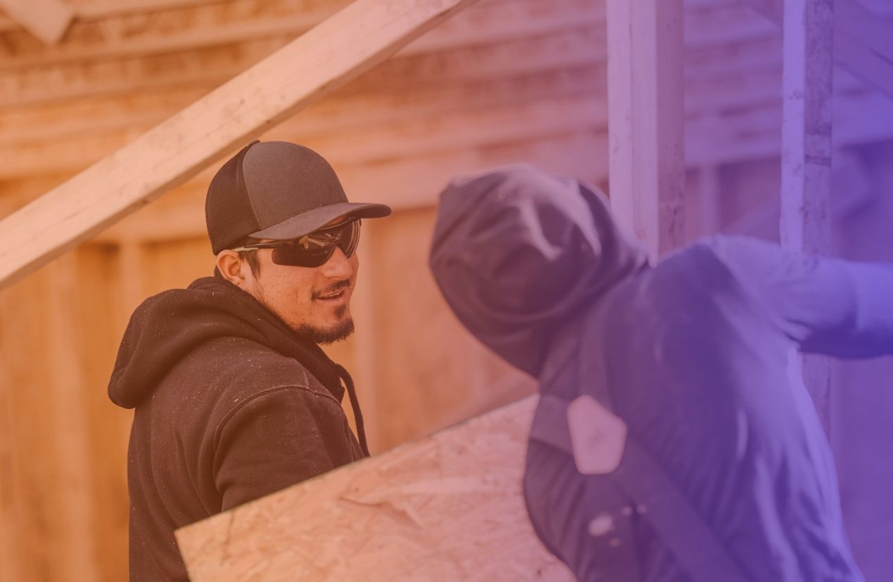 A woman is sitting in a rocking chair on a porch.