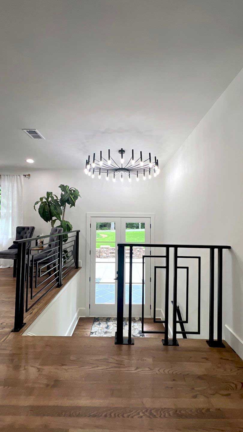 A dining room with a table and chairs and a chandelier.