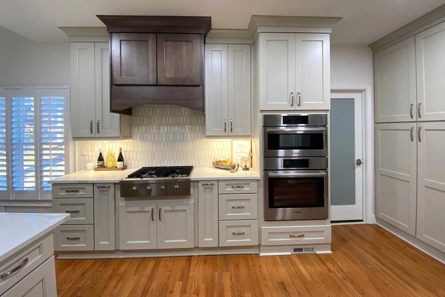 A kitchen with white cabinets and stainless steel appliances