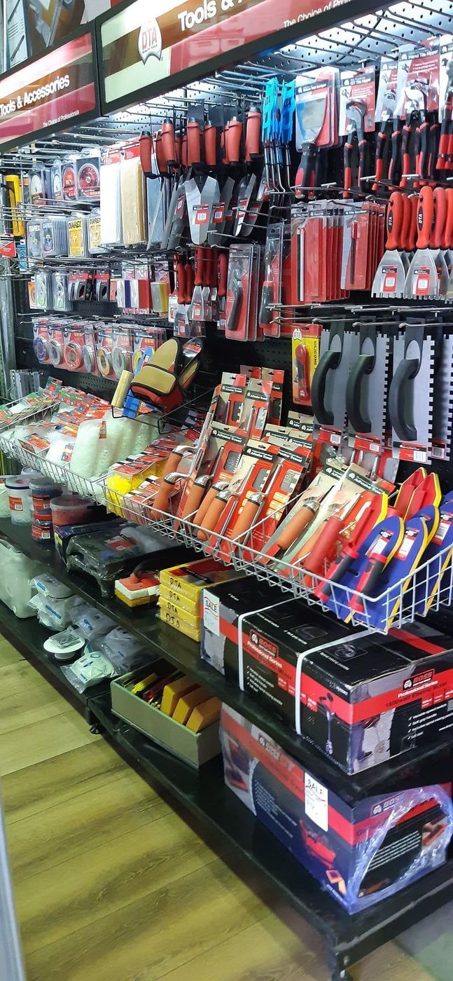 A Hardware Store Aisle Displays Various Tools, With Packed Shelves and Bright Red Packaging — Cooloola Tile Company in Gympie, QLD