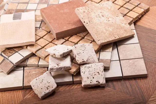 Various Tile Samples in Shades of Beige, Brown, and Red, Arranged on a Wooden Surface — Cooloola Tile Company in Hervey Bay, QLD
