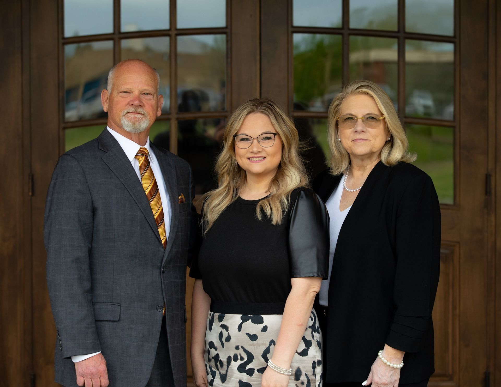 A group of people are posing for a picture together in an office.