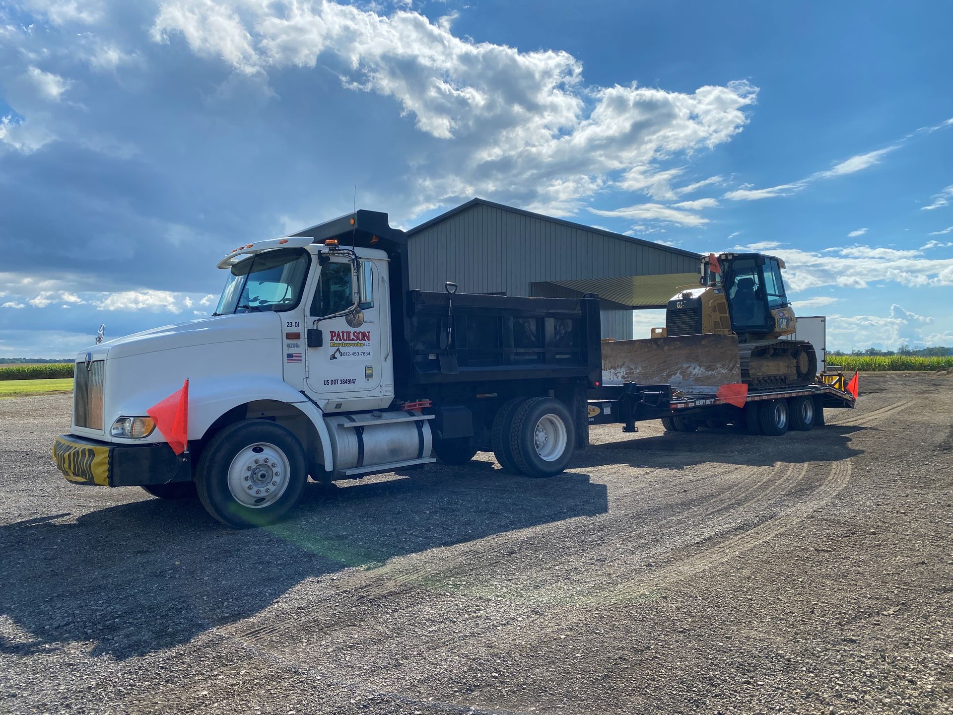 A yellow excavator is digging in a pile of dirt.