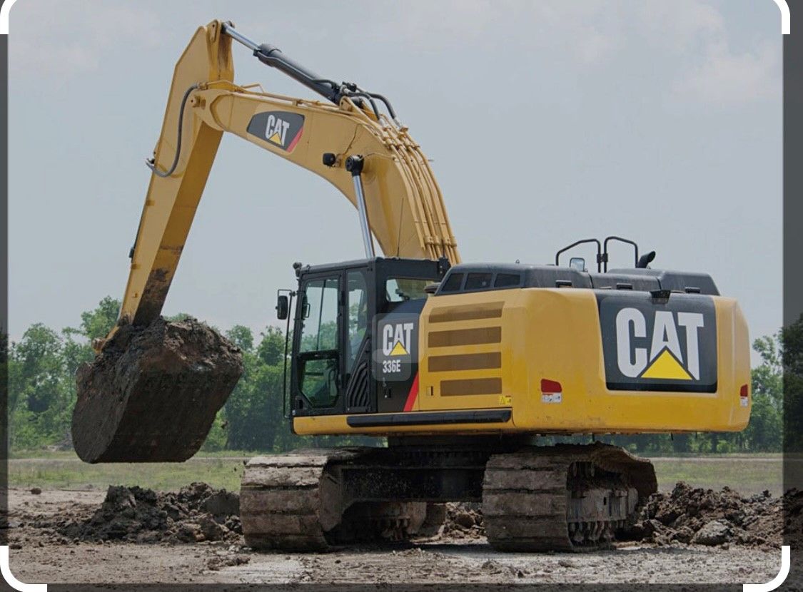 A cat excavator is digging a hole in the dirt