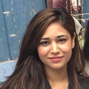 A man in a suit and tie is smiling for the camera