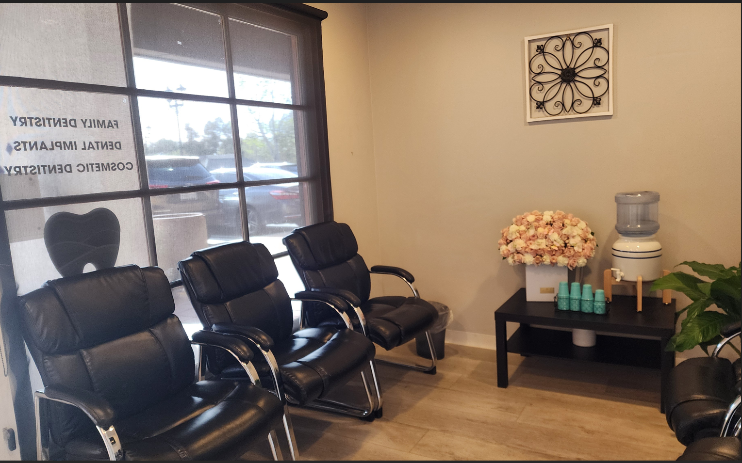 A waiting room with black chairs and a table