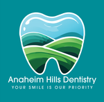 A logo for anaheim hills dentistry shows a tooth with mountains in the background