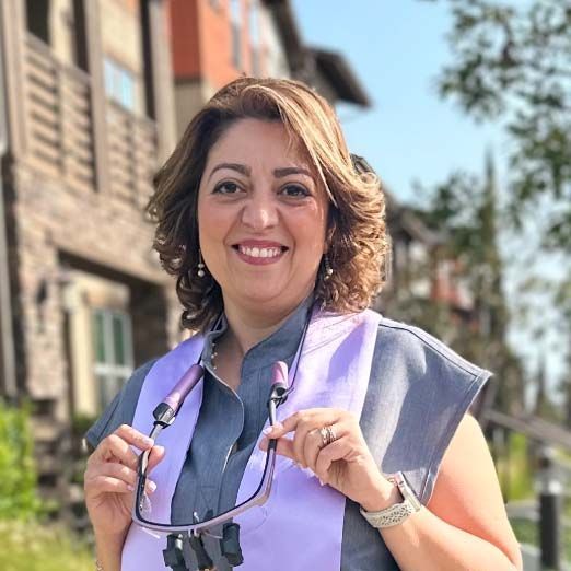 A man in a suit and tie is smiling for the camera