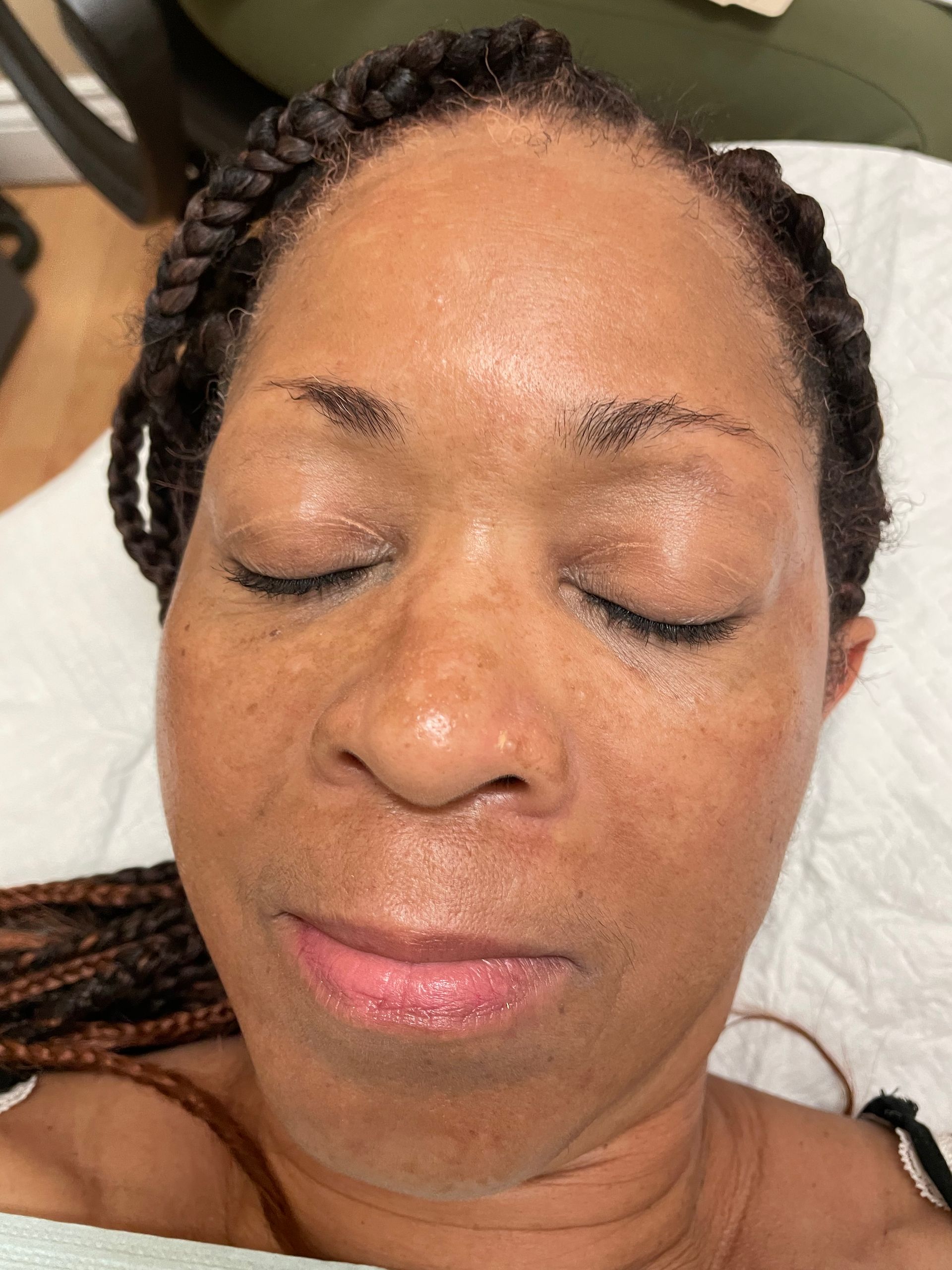 A close up of a woman 's face with her eyes closed