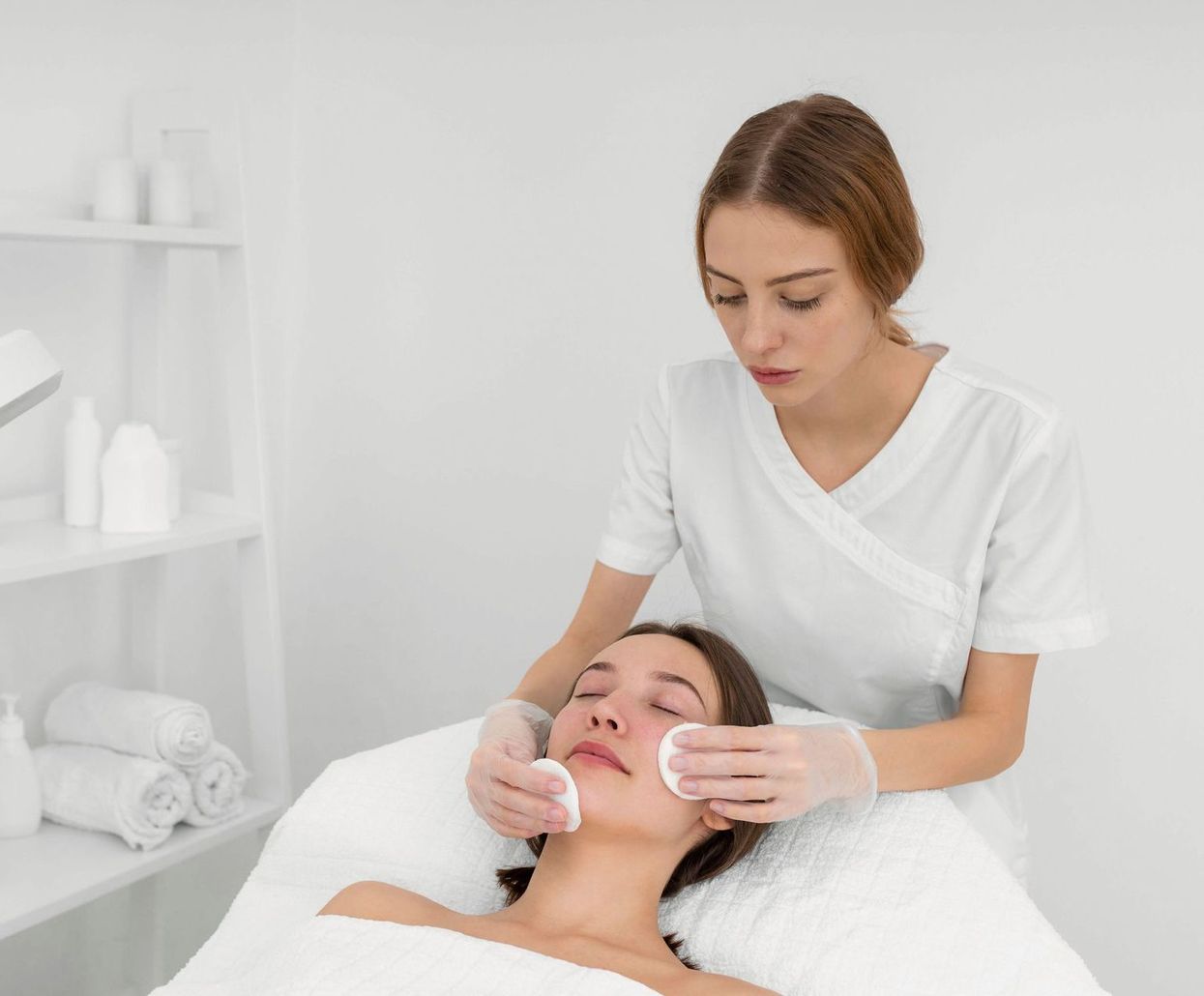 A woman is getting a facial treatment at a spa.