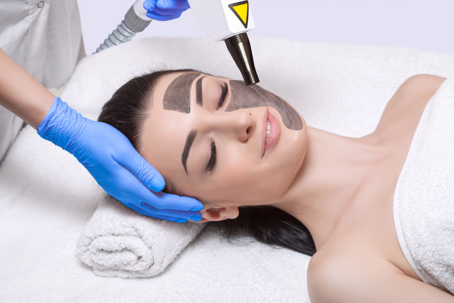 A woman is getting a facial treatment at a spa.