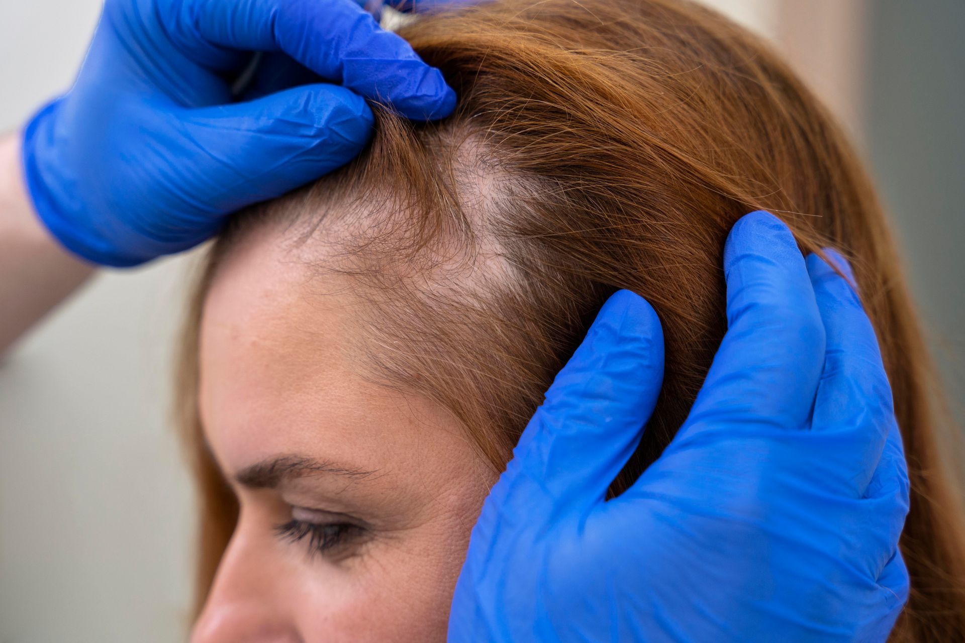 A man is getting an injection in his head by a doctor.