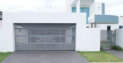 gray aluminium slatted garage door on modern white house