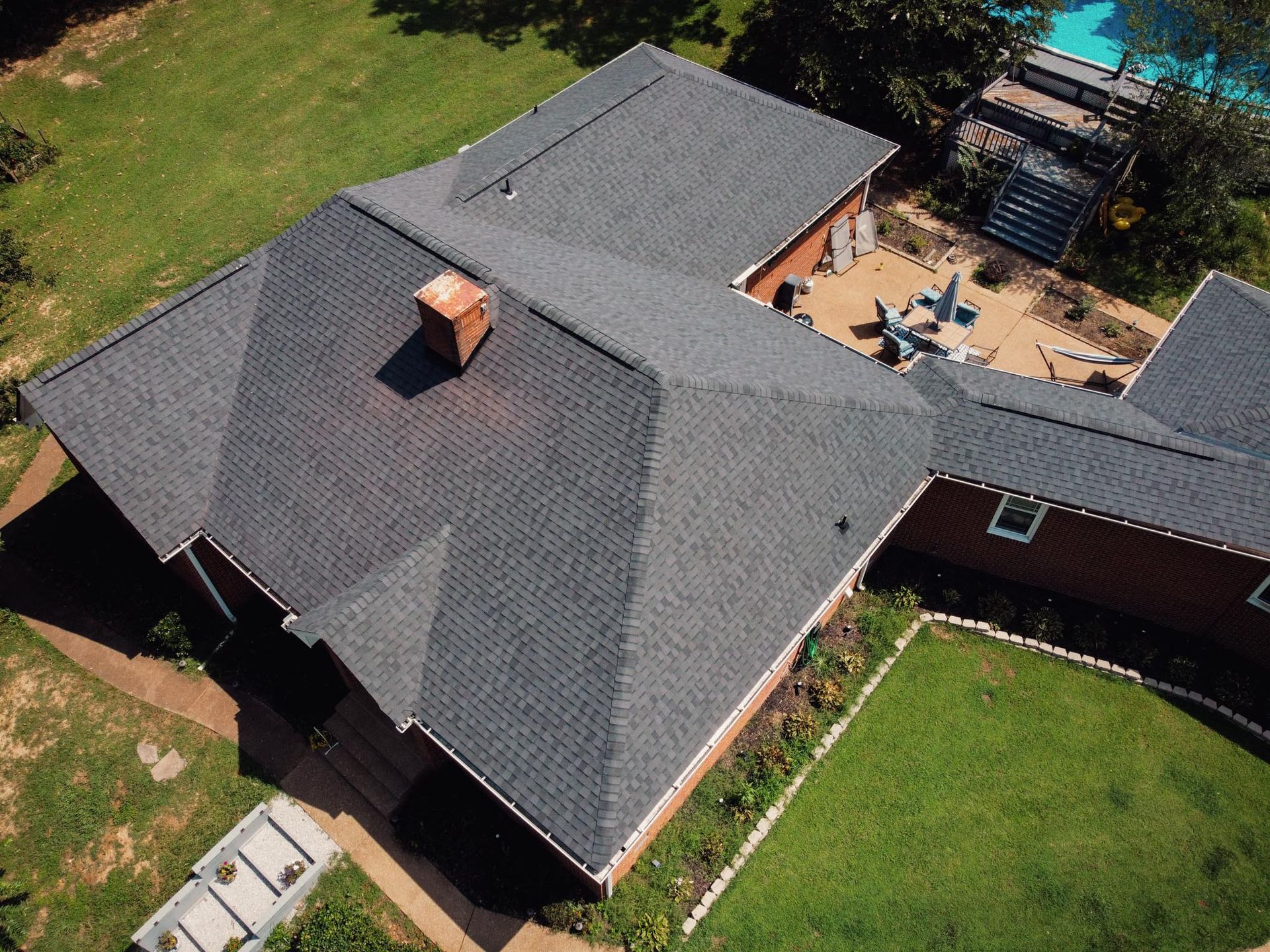 An aerial view of a house with a black roof