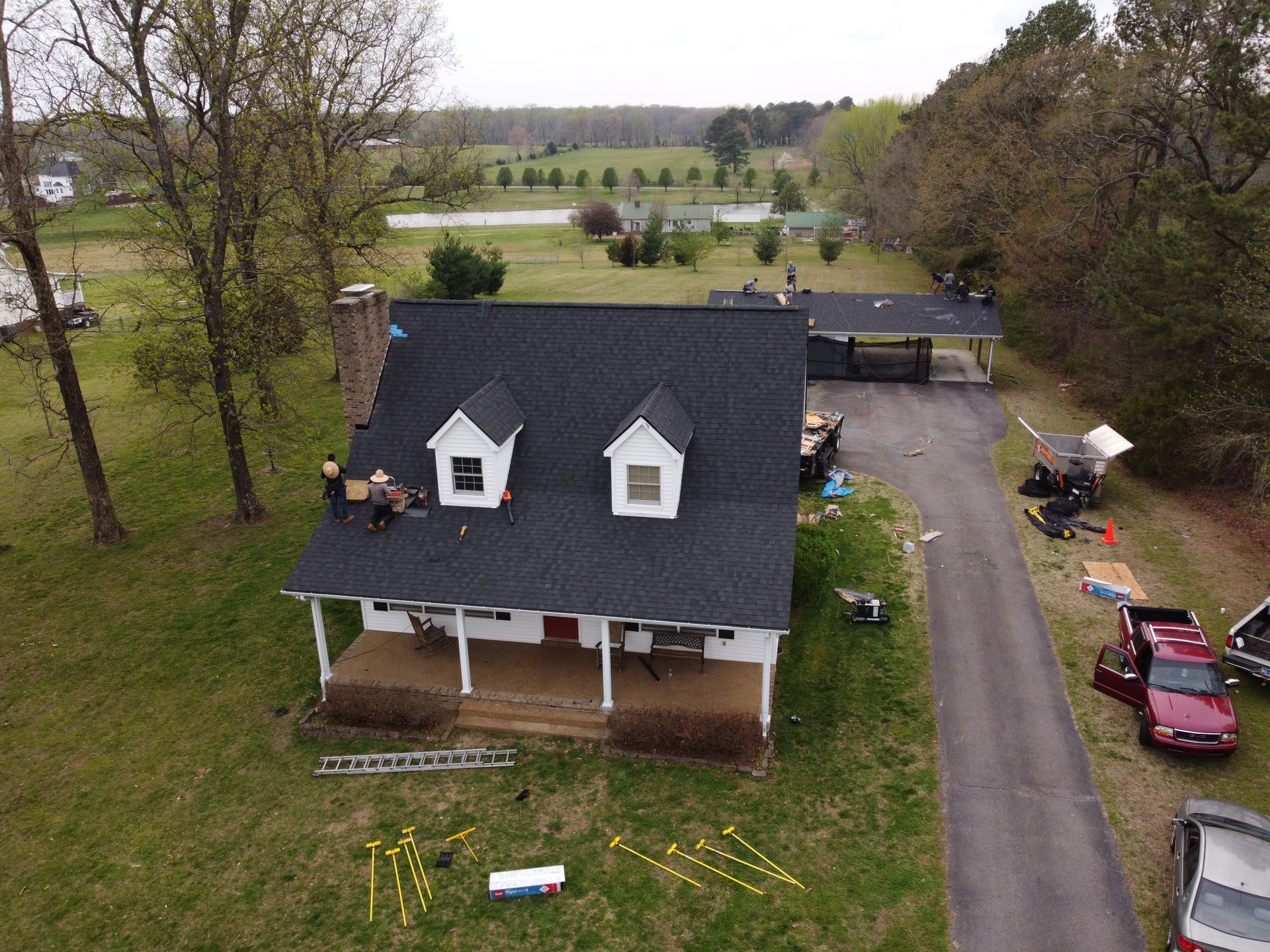 An aerial view of a house with a new roof being installed.